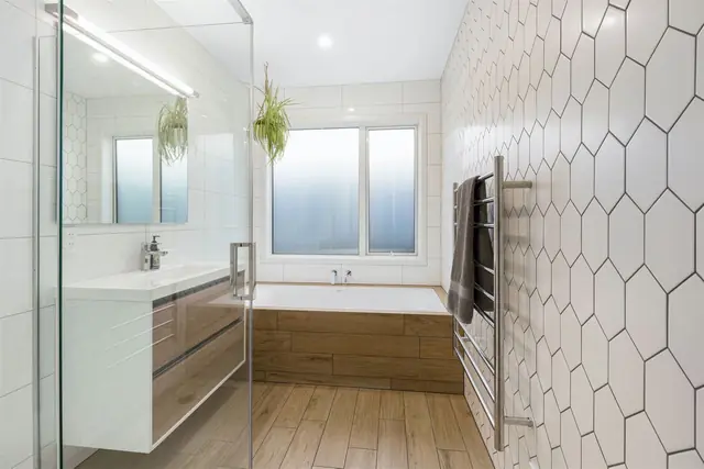 Bathroom with hexagon wall tiles, built-in bath and wall-hung vanity