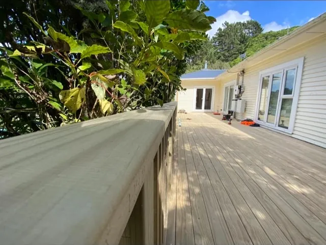 Timber deck running along the side of a weatherboard house